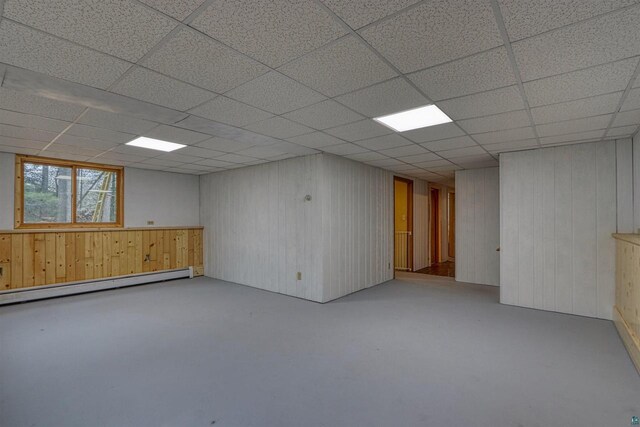 10749 N Namekagon Ln, Hayward, WI 54843 - basement featuring a drop ceiling, wooden walls, and a baseboard heating unit