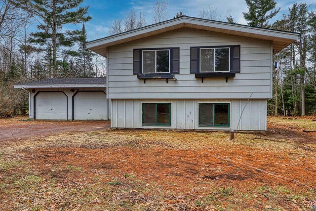 10749 N Namekagon Ln, Hayward, WI 54843 - rear view of property with dirt driveway and a garage