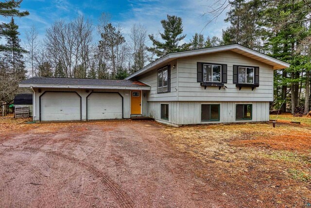 10749 N Namekagon Ln, Hayward, WI 54843 - split level home featuring a garage and dirt driveway