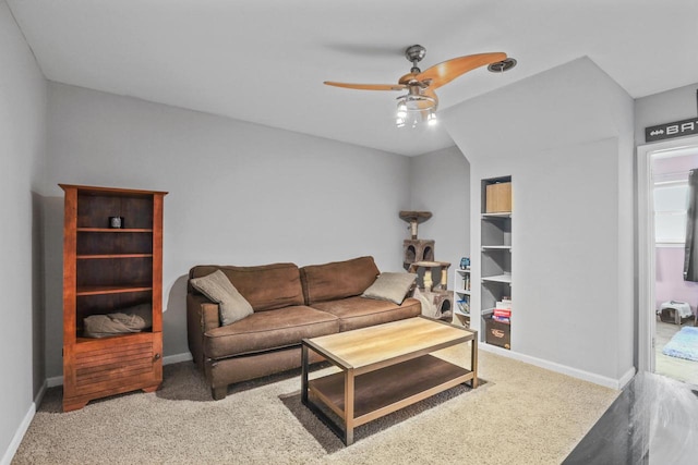 living room with carpet flooring, ceiling fan, and baseboards