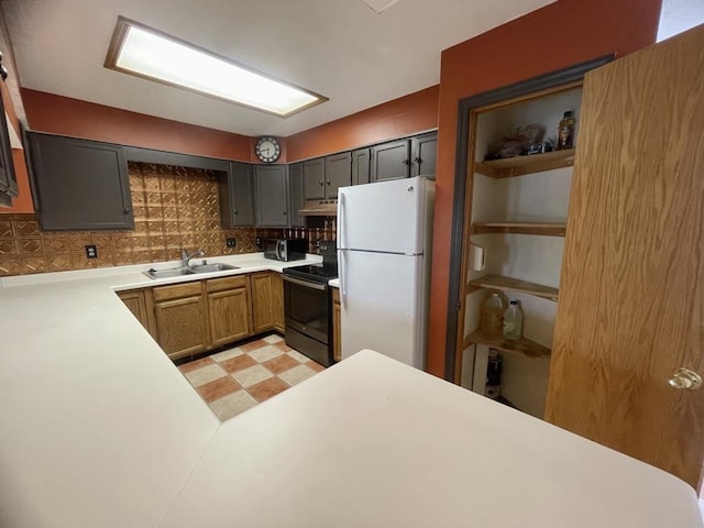 kitchen with a sink, light countertops, under cabinet range hood, black appliances, and light floors