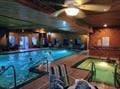 indoor pool featuring ceiling fan