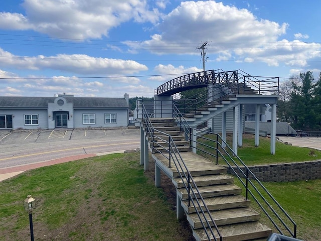view of community featuring a yard and stairway