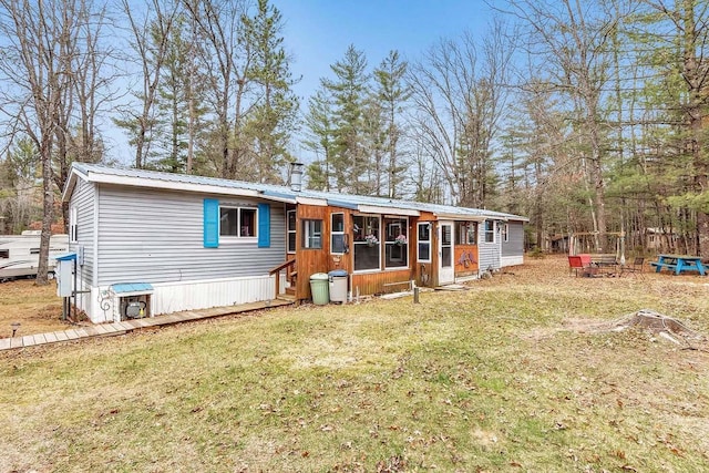 11689 Eagle Bluff Ln, Crivitz, WI 54114 - back of property with metal roof, a lawn, and entry steps