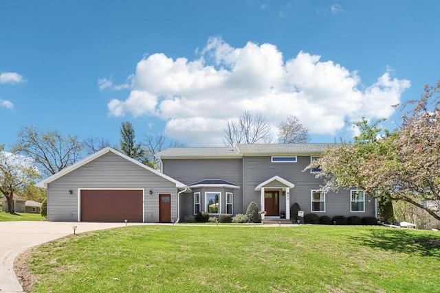 911 Fawn Ct, Wisconsin Dells, WI 53965 - view of front of home featuring driveway, a garage, and a front yard