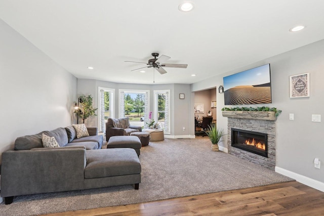 911 Fawn Ct, Wisconsin Dells, WI 53965 - living area with baseboards, ceiling fan, a stone fireplace, recessed lighting, and wood finished floors