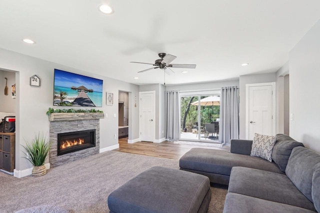 911 Fawn Ct, Wisconsin Dells, WI 53965 - living area with carpet flooring, ceiling fan, a stone fireplace, recessed lighting, and baseboards