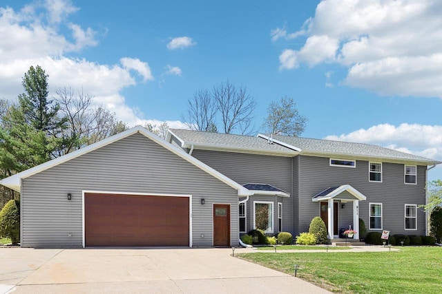 911 Fawn Ct, Wisconsin Dells, WI 53965 - view of front of home featuring a front yard, a garage, and concrete driveway