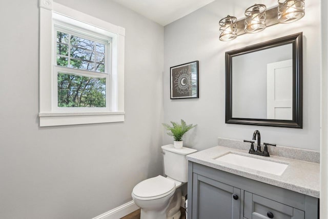 911 Fawn Ct, Wisconsin Dells, WI 53965 - half bath featuring toilet, vanity, and baseboards