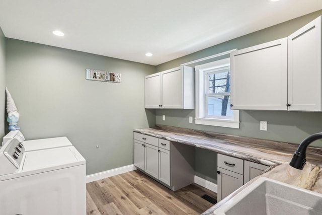 911 Fawn Ct, Wisconsin Dells, WI 53965 - laundry room with cabinet space, separate washer and dryer, light wood-style flooring, baseboards, and recessed lighting