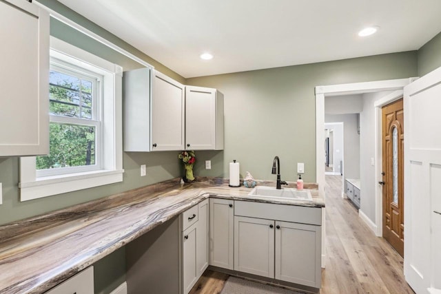 911 Fawn Ct, Wisconsin Dells, WI 53965 - kitchen with a sink, light wood finished floors, light countertops, and recessed lighting