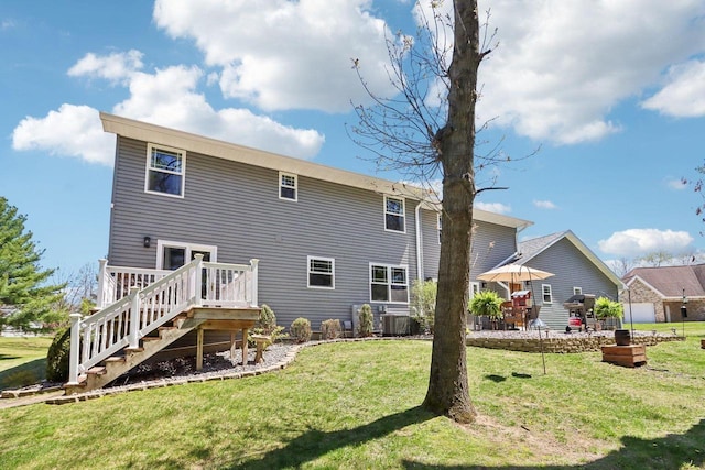911 Fawn Ct, Wisconsin Dells, WI 53965 - back of house with a deck, a lawn, stairway, and cooling unit