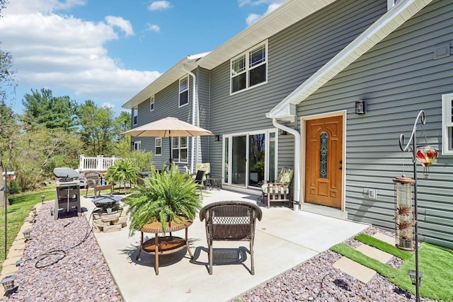 911 Fawn Ct, Wisconsin Dells, WI 53965 - back of house with a patio area and an outdoor fire pit