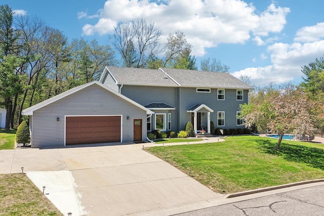 911 Fawn Ct, Wisconsin Dells, WI 53965 - view of front facade featuring a front lawn, a garage, and driveway