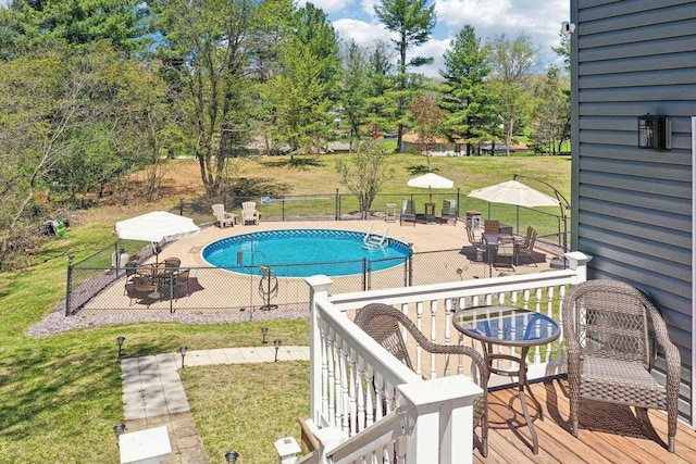 911 Fawn Ct, Wisconsin Dells, WI 53965 - view of pool featuring a patio area, a wooden deck, outdoor dining area, and view of wooded area