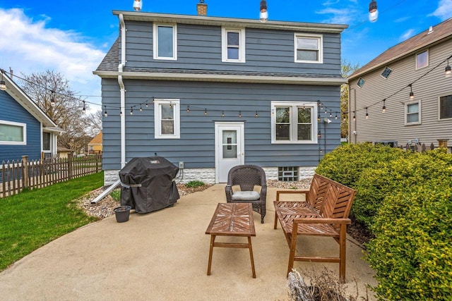 back of property with a patio, fence, a chimney, and a shingled roof