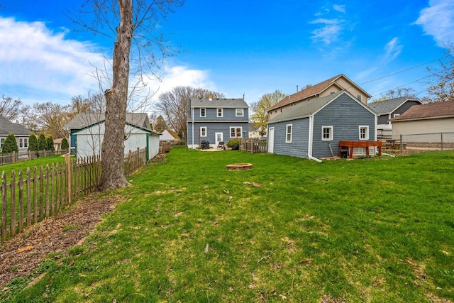 view of yard with a fenced backyard and an outdoor fire pit