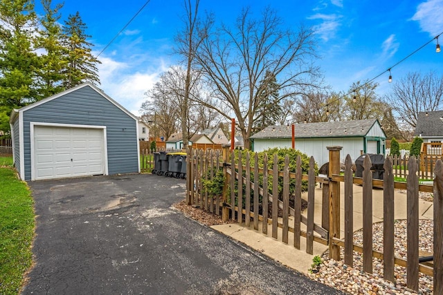 exterior space featuring a gate, fence, a residential view, and driveway