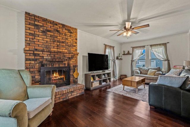 living room featuring a brick fireplace, ceiling fan, ornamental molding, and hardwood / wood-style flooring