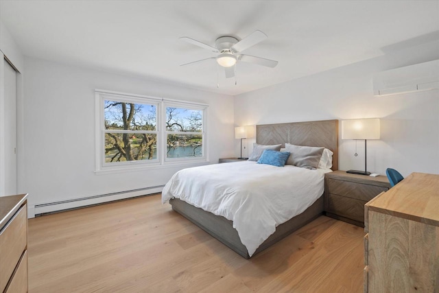 bedroom with light wood-style floors, a ceiling fan, an AC wall unit, and baseboard heating