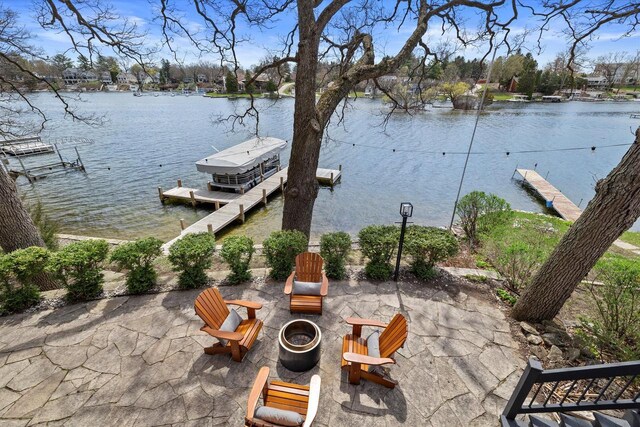 view of patio / terrace featuring a water view and a dock