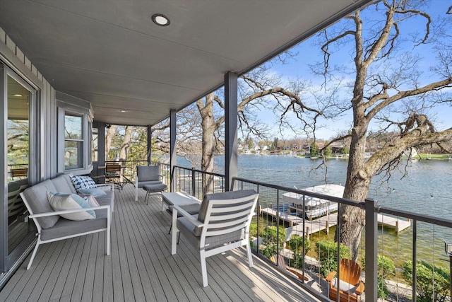 wooden deck featuring a water view and outdoor lounge area