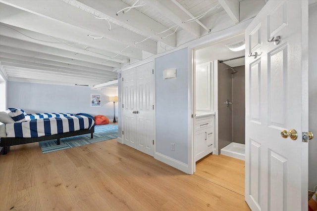 bedroom featuring light wood finished floors and baseboards