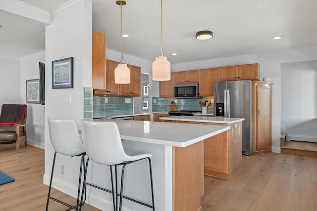 kitchen featuring stainless steel appliances, light countertops, light wood finished floors, a peninsula, and backsplash