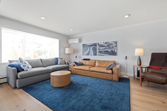 living room with crown molding, recessed lighting, and light wood-style flooring