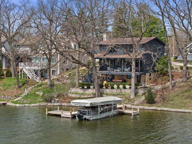 view of dock featuring stairway, a water view, and boat lift