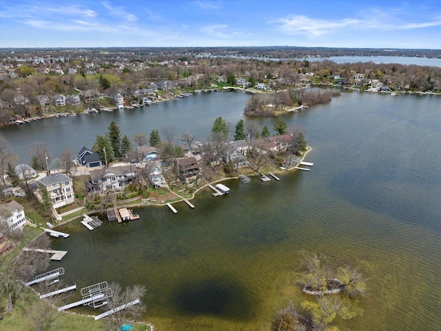 drone / aerial view with a residential view and a water view