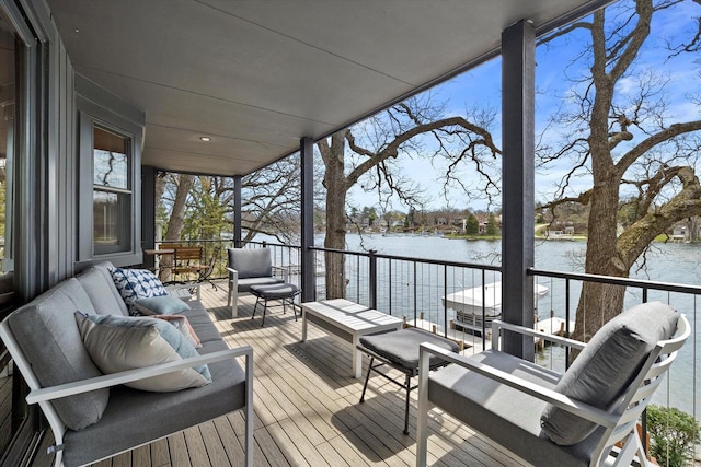 deck featuring an outdoor living space and a water view