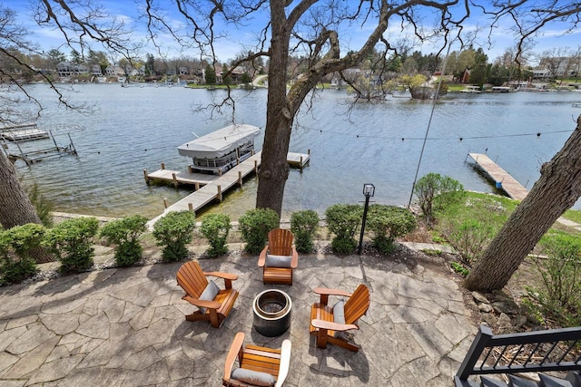 view of patio / terrace featuring a water view and a dock