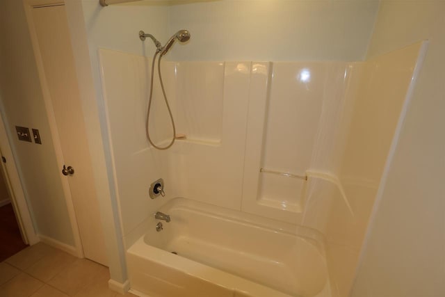 bathroom with tile patterned flooring and bathtub / shower combination