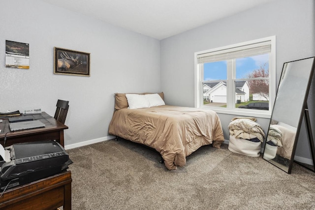 bedroom with baseboards and carpet