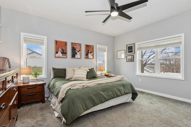 carpeted bedroom with baseboards, a ceiling fan, and multiple windows