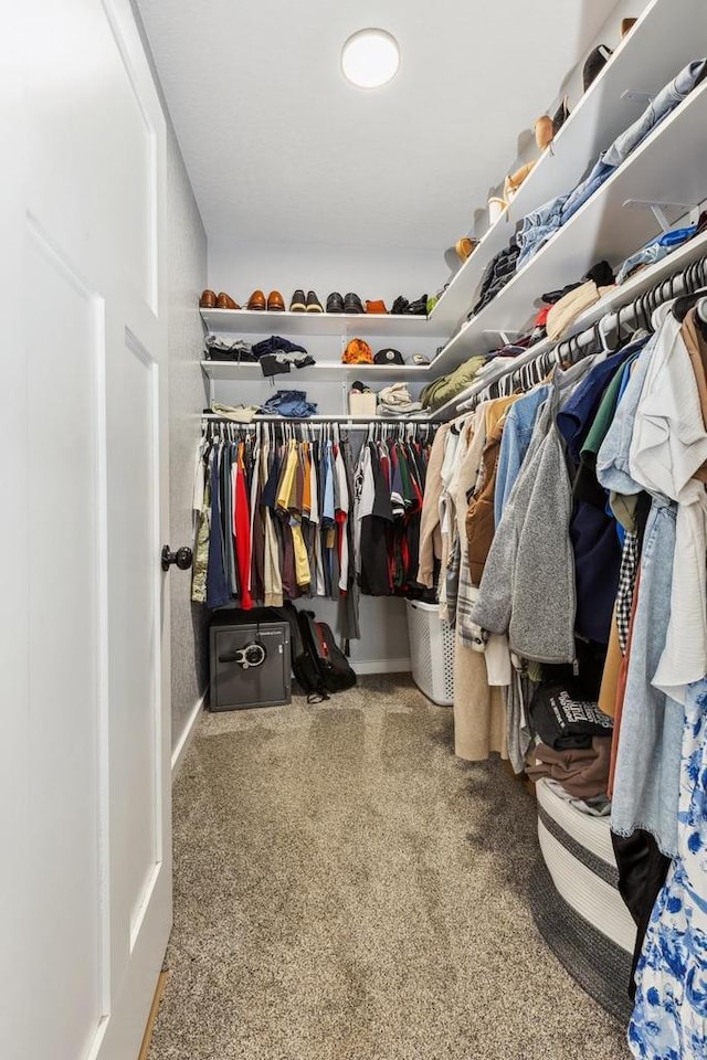 walk in closet with carpet