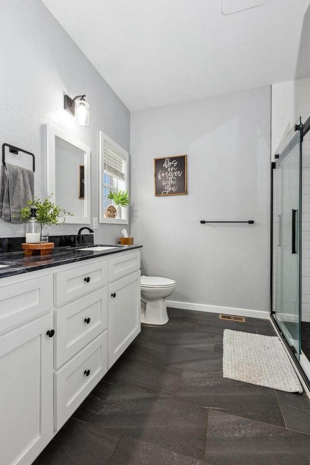 bathroom featuring vanity, toilet, a stall shower, visible vents, and wood finished floors
