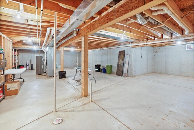 unfinished below grade area featuring heating unit and water heater