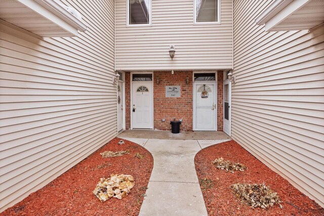 entrance to property with brick siding