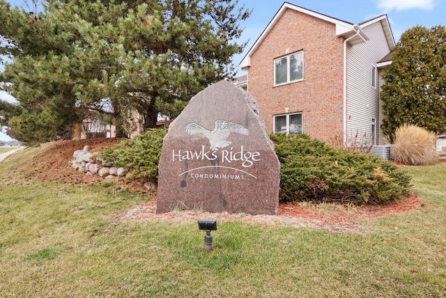 community / neighborhood sign with a yard