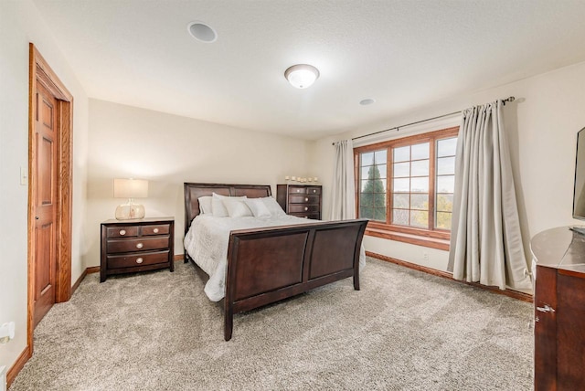 carpeted bedroom featuring baseboards