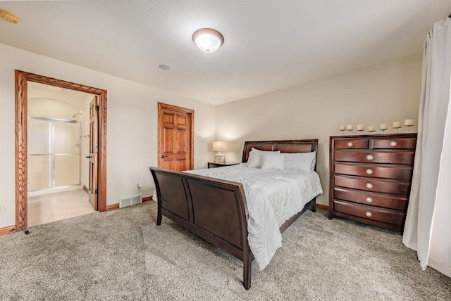 carpeted bedroom featuring visible vents and baseboards