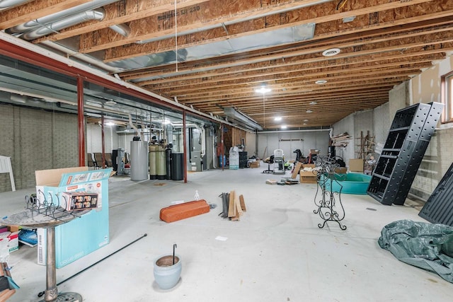 unfinished basement featuring heating unit and gas water heater