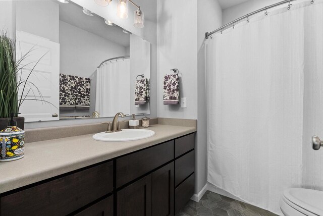 bathroom featuring vanity and toilet