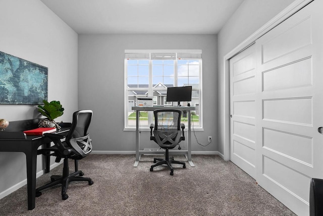 carpeted office space with baseboards