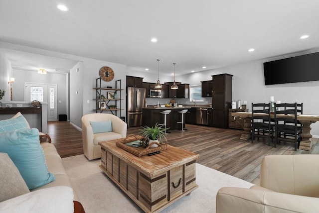 living room featuring recessed lighting and light wood finished floors