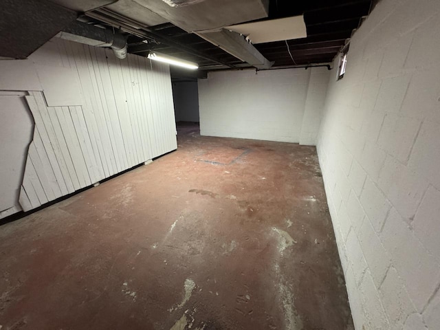 unfinished basement with concrete block wall