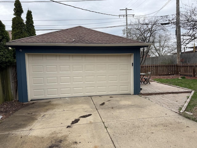 detached garage featuring fence