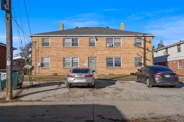 exterior space featuring cooling unit and a chimney